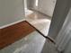 Home entrance with tiled foyer leading to a hardwood transition and bare concrete flooring at 10814 Newbridge Dr, Riverview, FL 33579