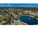 Aerial view of the community, showcasing the lake and surrounding landscape at 1725 Pine Ridge E Way # E, Palm Harbor, FL 34684