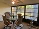 Screened in patio with dining table and chairs and outdoor views at 1725 Pine Ridge E Way # E, Palm Harbor, FL 34684
