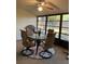Enclosed patio area featuring a dining table and chairs, perfect for outdoor dining at 1725 Pine Ridge E Way # E, Palm Harbor, FL 34684
