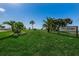 Well-maintained community entrance sign amidst lush landscaping at 1725 Pine Ridge E Way # E, Palm Harbor, FL 34684