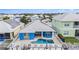 Aerial view showcases a private pool and deck, perfect for outdoor relaxation and entertaining, surrounded by lush landscaping at 6408 Key Island Ave, Apollo Beach, FL 33572