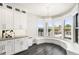 Bright kitchen nook features a bay window with seating, custom cabinetry, and views of the outdoor scenery at 6408 Key Island Ave, Apollo Beach, FL 33572