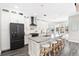 Modern kitchen with granite countertops, black stainless steel appliances, and a breakfast bar with seating at 6408 Key Island Ave, Apollo Beach, FL 33572