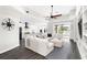Spacious living room features a modern ceiling fan, plush seating, and seamless access to a sun-soaked outdoor space at 6408 Key Island Ave, Apollo Beach, FL 33572