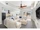 Bright, open-concept living room featuring a large sectional sofa and seamless access to the outdoor pool area at 6408 Key Island Ave, Apollo Beach, FL 33572