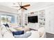 Relaxing living room showcasing a large sectional, built-in shelving, and access to the outdoor deck at 6408 Key Island Ave, Apollo Beach, FL 33572