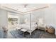 Serene main bedroom showcasing a four-poster bed, stylish rug, and sliding glass doors leading to outdoor at 6408 Key Island Ave, Apollo Beach, FL 33572