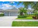 Charming home with a three-car garage, manicured lawn, and beautiful landscaping at 6429 Seasound Dr, Apollo Beach, FL 33572