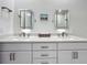 Bright bathroom featuring dual sinks, quartz countertops, framed mirrors, and modern fixtures at 644 3Rd S Ave # 302, St Petersburg, FL 33701