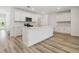 Well-lit kitchen featuring white cabinets, an island, and stainless steel appliances at 6690 Michael Favor Way, Wesley Chapel, FL 33545