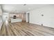 Large living room with hardwood floors leading to an open kitchen at 6690 Michael Favor Way, Wesley Chapel, FL 33545