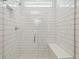 Modern bathroom shower with white subway tile and a glass door at 6690 Michael Favor Way, Wesley Chapel, FL 33545
