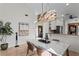 Dining area with modern chandelier and a wet bar nearby at 7710 Palm Aire Ln, Sarasota, FL 34243