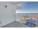 Enjoy water views from the balcony, featuring a white railing and a view of the street and tropical foliage below at 1350 Gulf Blvd, Clearwater, FL 33767