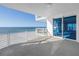 Balcony featuring a ocean view and glass sliding doors into a sunlit living space at 1350 Gulf Blvd, Clearwater, FL 33767