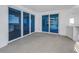 A view of the balcony with blue sliding glass doors that lead to the beach and overlook other balconies at 1350 Gulf Blvd, Clearwater, FL 33767