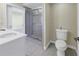 Bathroom featuring a spacious shower, toilet and vanity with a large sink at 1350 Gulf Blvd, Clearwater, FL 33767