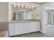 The bathroom features a double vanity, granite countertops, modern lighting, and access to a walk-in shower and toilet at 1350 Gulf Blvd, Clearwater, FL 33767