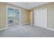 Bright bedroom with gray carpet, balcony access and a stunning view of the water at 1350 Gulf Blvd, Clearwater, FL 33767