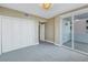 Comfortable bedroom with sliding glass doors to balcony and ensuite bathroom at 1350 Gulf Blvd, Clearwater, FL 33767