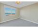 Cozy bedroom featuring neutral walls and carpet and a large window with water views at 1350 Gulf Blvd, Clearwater, FL 33767