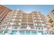 View of a modern condominium exterior with staggered balconies and glass railings offering stunning views at 1350 Gulf Blvd, Clearwater, FL 33767