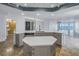 Bright, open kitchen design featuring large marble countertop, island, stainless steel appliances and lighting at 1350 Gulf Blvd, Clearwater, FL 33767