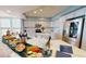 Open kitchen layout features an island, stainless steel appliances, white countertop, and eat-in space at 1350 Gulf Blvd, Clearwater, FL 33767