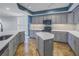 Modern kitchen with stone countertops, stainless steel appliances, island and decorative backsplash at 1350 Gulf Blvd, Clearwater, FL 33767