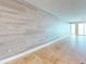 Bright, open living room featuring wood-look accent wall and gorgeous tile flooring at 1350 Gulf Blvd, Clearwater, FL 33767