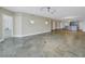 Open living space with stone floors, recessed lighting, and doorway to the kitchen at 1350 Gulf Blvd, Clearwater, FL 33767