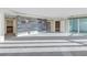 A large main bedroom features modern lighting, a wall accent, and access to a balcony with beautiful outdoor views at 1350 Gulf Blvd, Clearwater, FL 33767