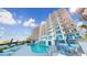 Resort-style pool with lounge chairs and umbrellas in a condo complex overlooking the beach at 1350 Gulf Blvd, Clearwater, FL 33767