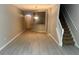 Spacious living room with modern flooring, staircase, and open access to kitchen at 14215 Waterville Cir, Tampa, FL 33626