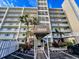 Exterior view of the condominium building, showing multiple floors, balconies, and well-maintained landscaping at 18650 Gulf Blvd # 413, Indian Shores, FL 33785