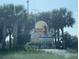Indian Shores community entrance with palm trees and well-maintained landscaping at 18650 Gulf Blvd # 413, Indian Shores, FL 33785