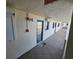 Hallway on a condo building, showing multiple doors with a view of the outside beach at 18650 Gulf Blvd # 413, Indian Shores, FL 33785