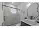Elegant bathroom with a frameless glass shower, modern vanity, and sleek black fixtures at 1905 W Erna Dr, Tampa, FL 33603