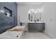 Bright bathroom with a modern double sink vanity, unique mirrors, and a luxurious soaking tub at 1905 W Erna Dr, Tampa, FL 33603