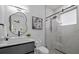 Contemporary bathroom featuring a walk-in shower and modern sink with unique mirror at 1905 W Erna Dr, Tampa, FL 33603