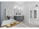 Modern bathroom featuring a soaking tub with caddy, and a double sink vanity with unique mirrors at 1905 W Erna Dr, Tampa, FL 33603