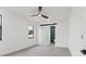 The bedroom offers a barn door access to the ensuite bathroom and a ceiling fan at 1905 W Erna Dr, Tampa, FL 33603