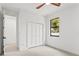 Bright bedroom features a closet and a window allowing for natural light and a ceiling fan with wooden blades at 1905 W Erna Dr, Tampa, FL 33603