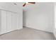 This bedroom features a ceiling fan and a large closet with bi-fold doors at 1905 W Erna Dr, Tampa, FL 33603