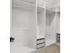 Custom walk-in closet with organizers for shoes and accessories, and clothes rods for easy storage at 1905 W Erna Dr, Tampa, FL 33603