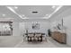 Dining room features modern light fixture, seating for six, and a view into the open-concept kitchen at 1905 W Erna Dr, Tampa, FL 33603