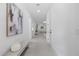Bright hallway with modern art and recessed lighting leads to an open concept living area with plenty of natural light at 1905 W Erna Dr, Tampa, FL 33603