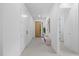 Bright hallway featuring recessed lighting and clean, neutral decor leads to a modern front door and living spaces at 1905 W Erna Dr, Tampa, FL 33603