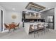 Well-lit kitchen featuring a modern island, stainless appliances, and a connecting dining area at 1905 W Erna Dr, Tampa, FL 33603